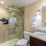Primary Bath - The primary bathroom at Maui Banyan H-214 has been completely remodeled, and features a walk-in shower with hand-held shower head.