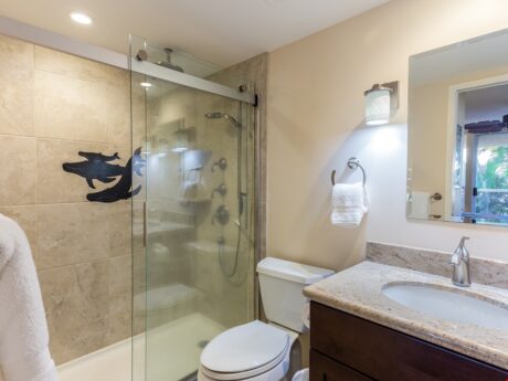 Primary Bath - The primary bathroom at Maui Banyan H-214 has been completely remodeled, and features a walk-in shower with hand-held shower head.