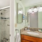 Luxurious Primary Bathroom - Between the large vanity, ample storage space and relaxing shower, you will find the bathroom an invigorating place to end the day.