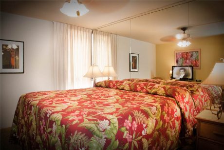 Our bedroom features a king size bed mirrored closet doors, TV & ceiling fan