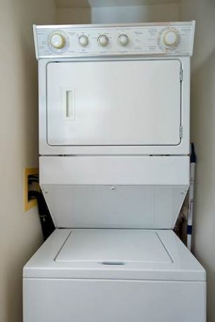 Stacked washer/dryer in unit