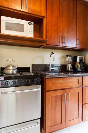 Fully appliance'd kitchen has microwave, coffee maker, blender, and more