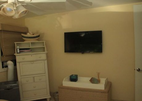 Flat-screen TV and secretary/storage check in second bedroom