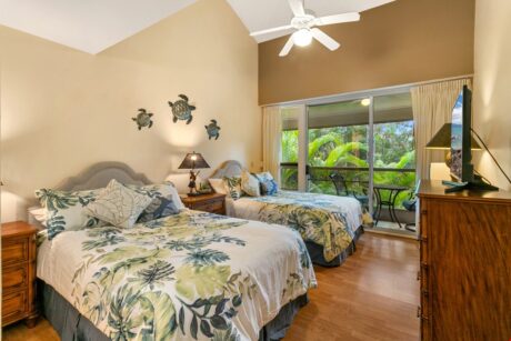 Second Bedroom - Two double beds outfit the second bedroom where you’ll also find a flat-screen TV and beautiful lanai just steps from the beds. Step outside to enjoy your morning coffee.