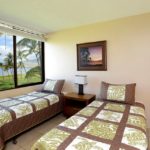Guest Bedroom - This airy and welcoming guest bedroom has two twin beds, and of course amazing beachfront views!